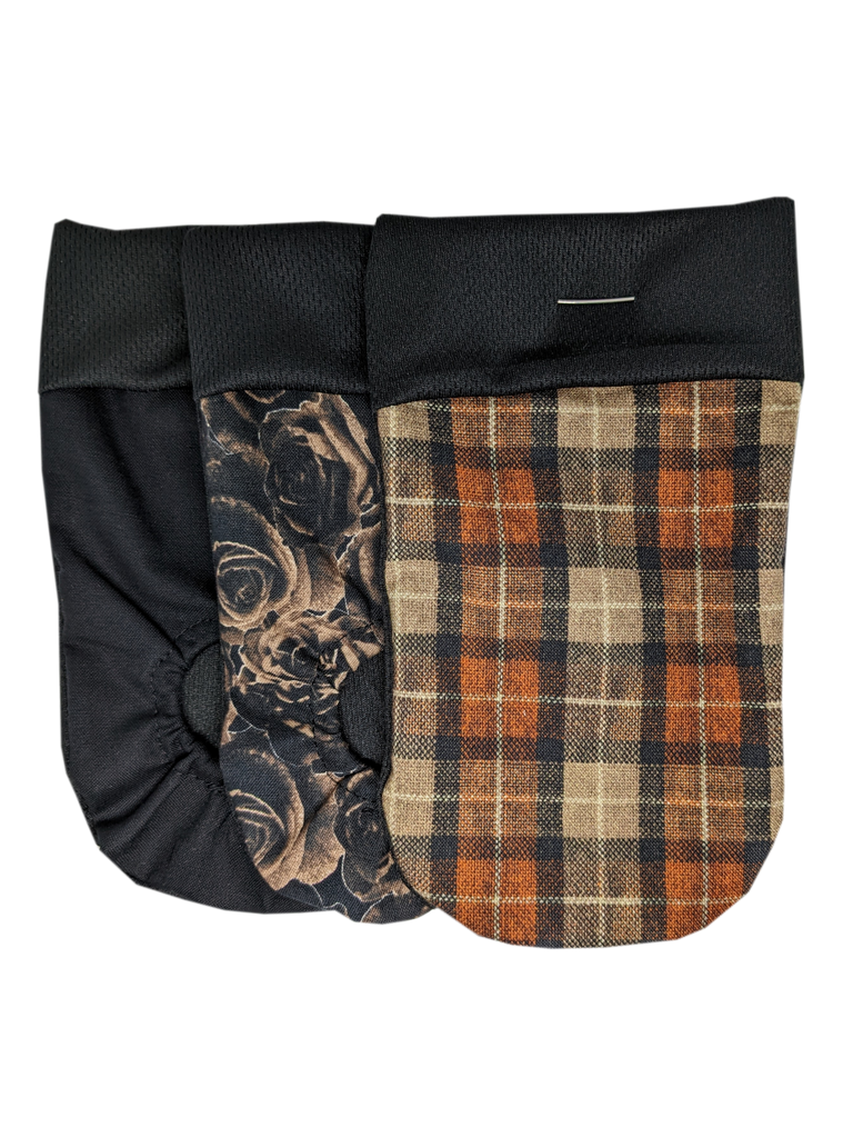  packing pouch for FTM, transmasculine and non-binary people. Joeys hold your packer in place. The Multipack contains 3 Joeys:  Orange Plaid No Hole: Orange, brown and yellow form a plaid pattern.  Roses Joeyo: Brown roses overlap on a black background.  Black Joeyo: Solid Black.